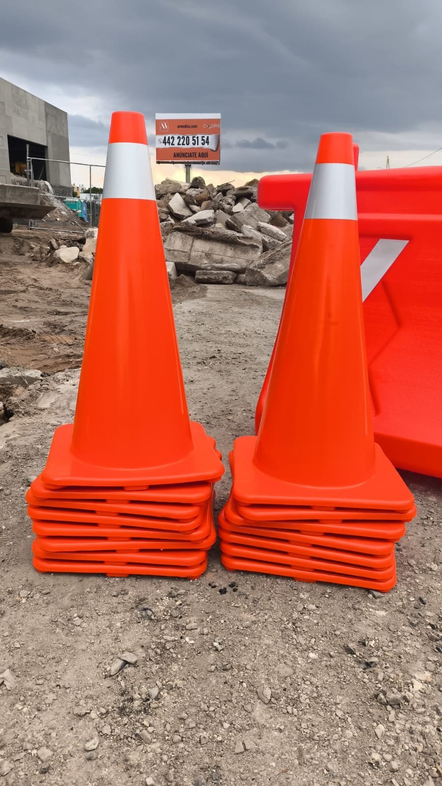 Conos viales apilados en una obra en construcción